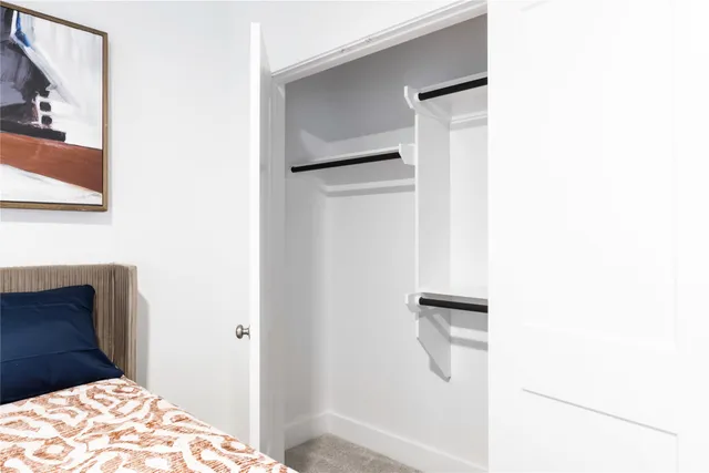 a bedroom with a bed and a rug