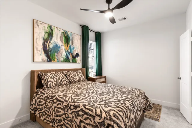 a bedroom with a bed and a painting on the wall