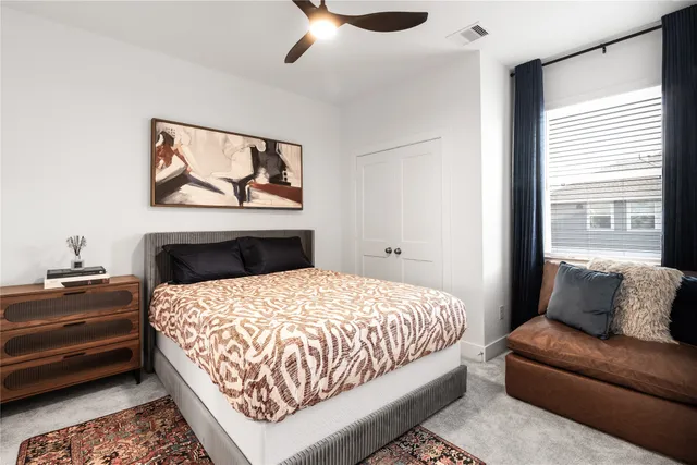 a bedroom with a bed couch and window