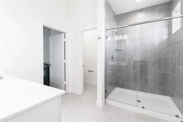 a bedroom with a bed a couch and a window