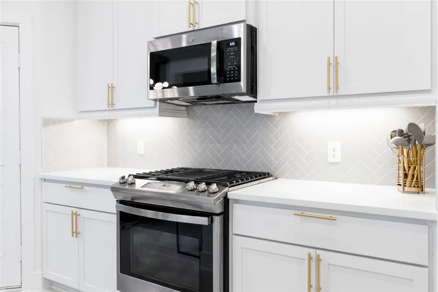 a kitchen with a stove and a microwave