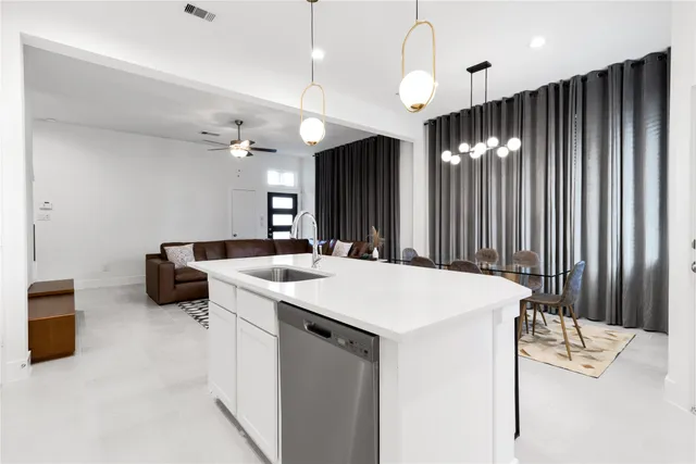 a kitchen with a sink and a refrigerator