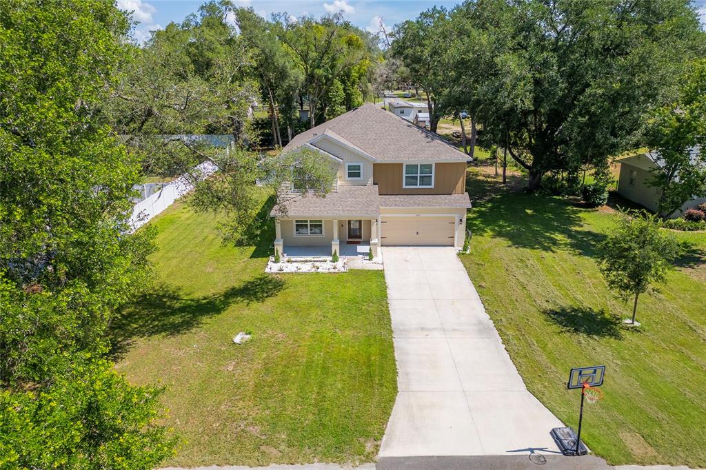 4331 Wayne Road Fruitland Park, FL 34731 - Photo 5 of 46 a aerial view of a house next to a yard with large trees