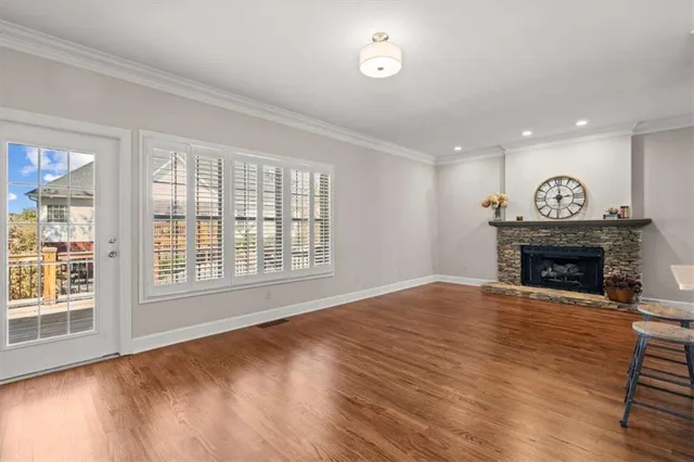 a view of an empty room with a window and fireplace