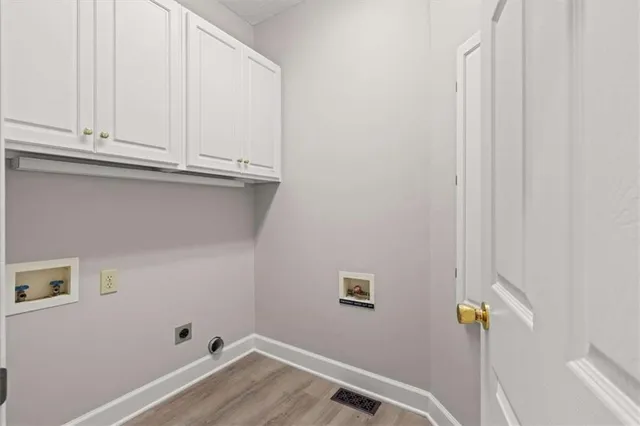 a bathroom with a granite countertop sink vanity mirror and toilet
