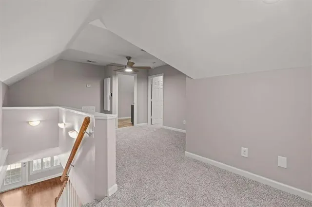 a view of an empty room with window and cabinet