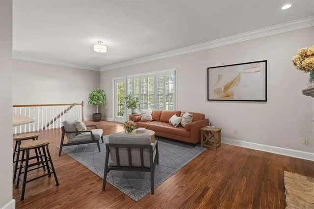 a living room with furniture and wooden floor