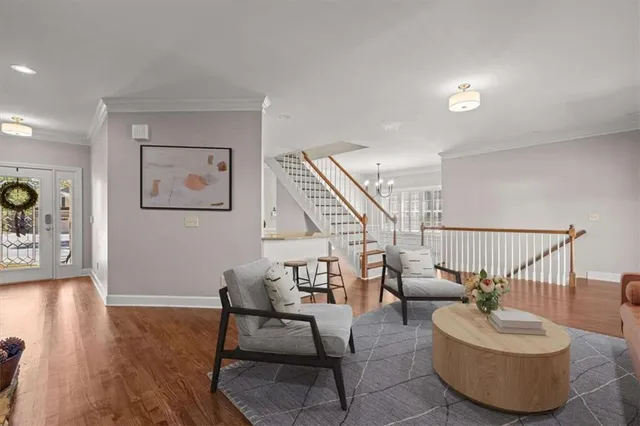 a living room with furniture and wooden floor