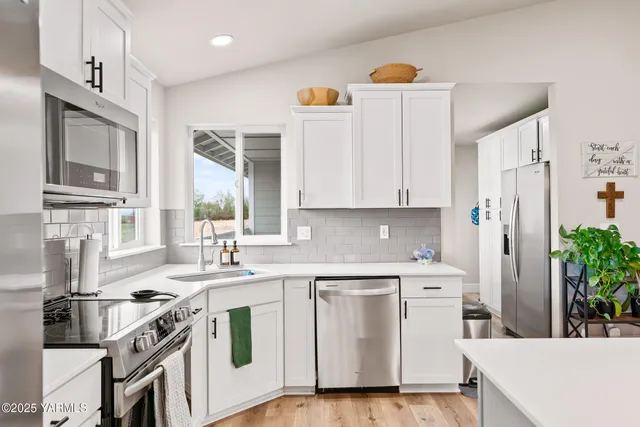 a kitchen with a sink stove and cabinets