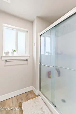 a bathroom with a double vanity sink mirror and shower