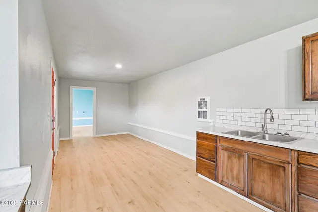 a view of a kitchen with a sink and a refrigerator