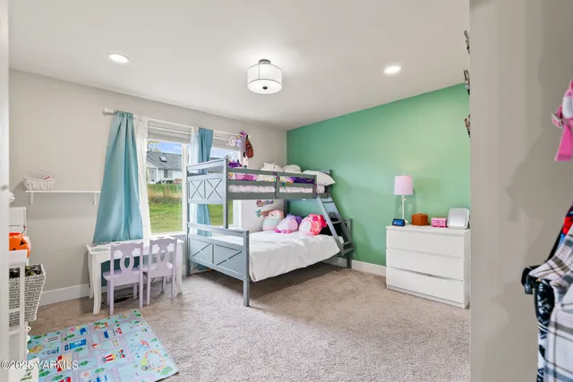 a bedroom with furniture and a small table