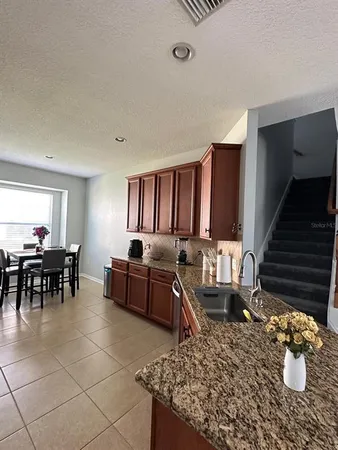 a living room with furniture a rug and a piano