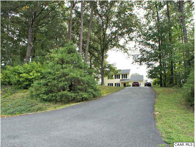 111 Rustling Oaks Way Ruckersville, VA 22968 - Photo 1 of 16 a tall buildings with trees in front of it