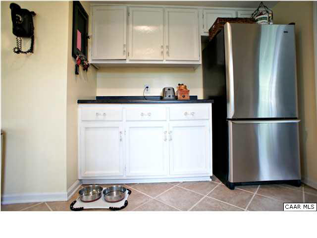 111 Rustling Oaks Way Ruckersville, VA 22968 - Photo 7 of 16 a kitchen with a refrigerator and cabinets