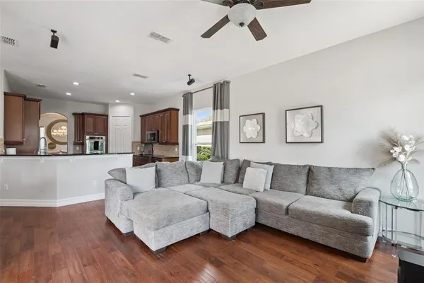 a living room with furniture and a wooden floor