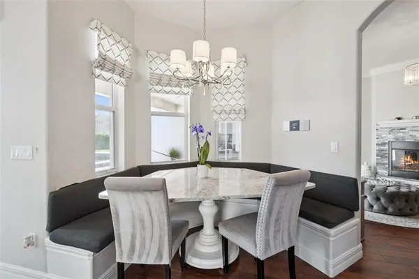 a view of a dining room with furniture wooden floor and chandelier