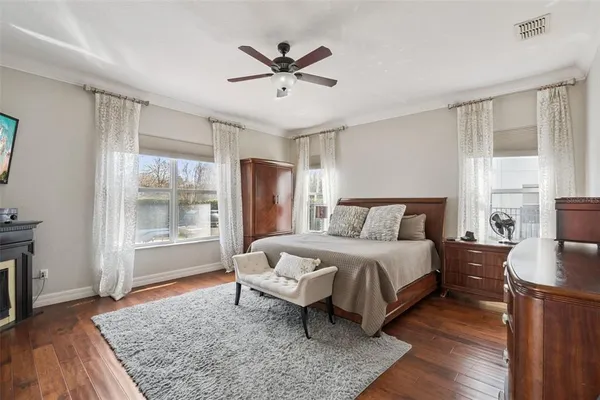 a spacious bedroom with a bed a window and a couch