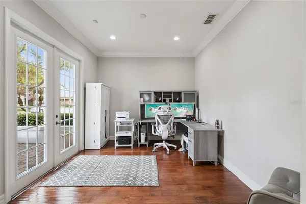 a view of a livingroom with a chair and front door