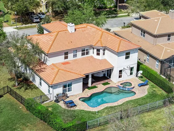 an aerial view of residential houses with yard and trees
