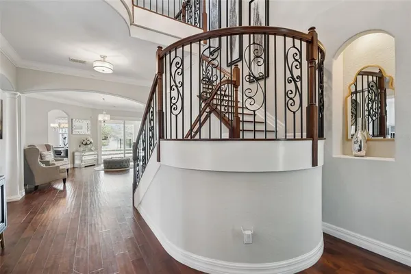 a view of living room and hallway with wooden floor