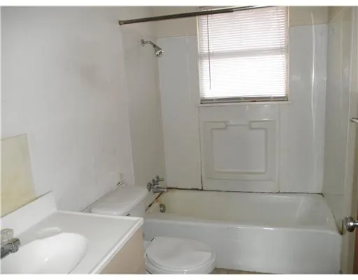 a white bath tub sitting next to a window