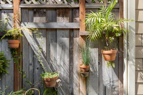 a view of a patio with table and chairs and potted plants