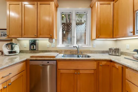 a kitchen with a sink cabinets and a window