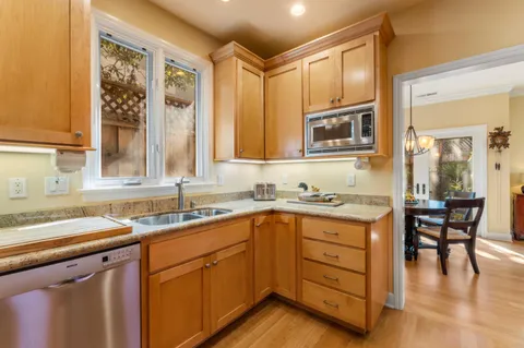 a kitchen with a sink stove and cabinets