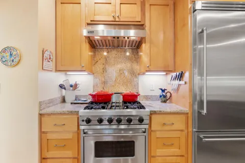 a kitchen with a stove and a refrigerator