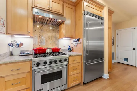 a kitchen with cabinets and stainless steel appliances