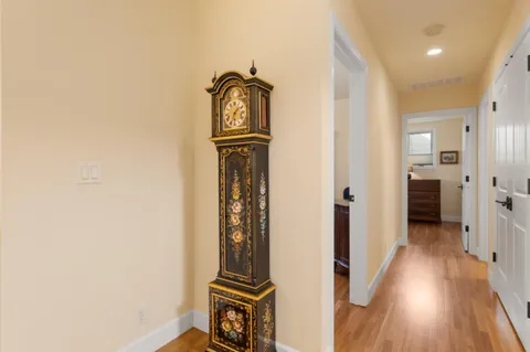 a view of a hallway with wooden floor