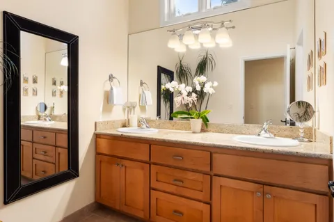 a bathroom with a double vanity sink and a mirror
