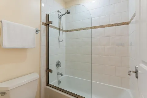 a bathroom with a shower and a toilet