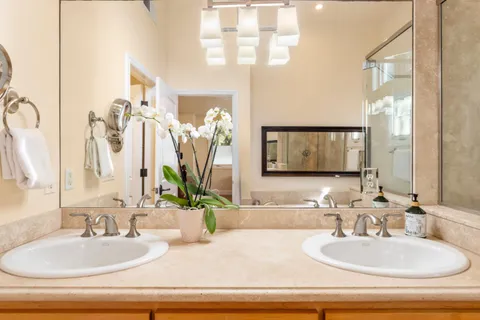 a bathroom with double vanity sinks and a mirror
