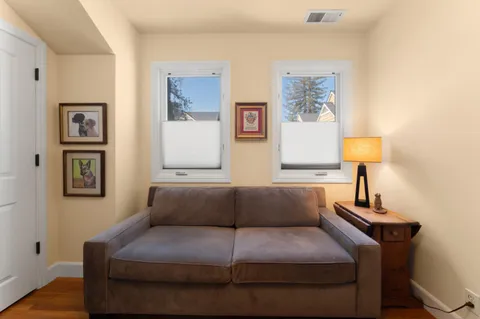 a living room with furniture and a lamp