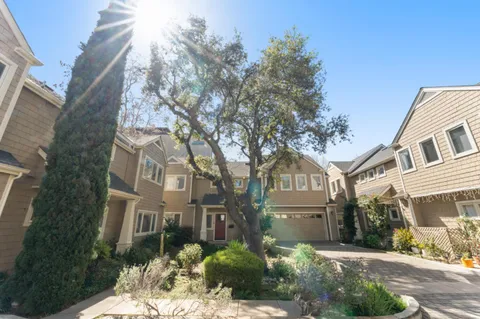a front view of a residential apartment building with a yard