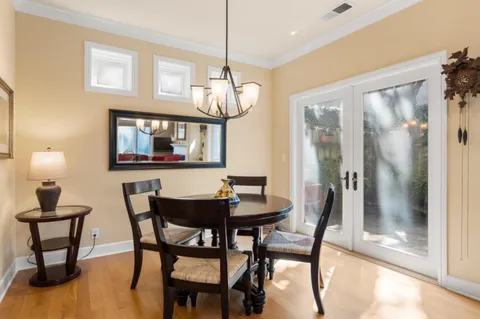 a view of a dining room with furniture and a chandelier