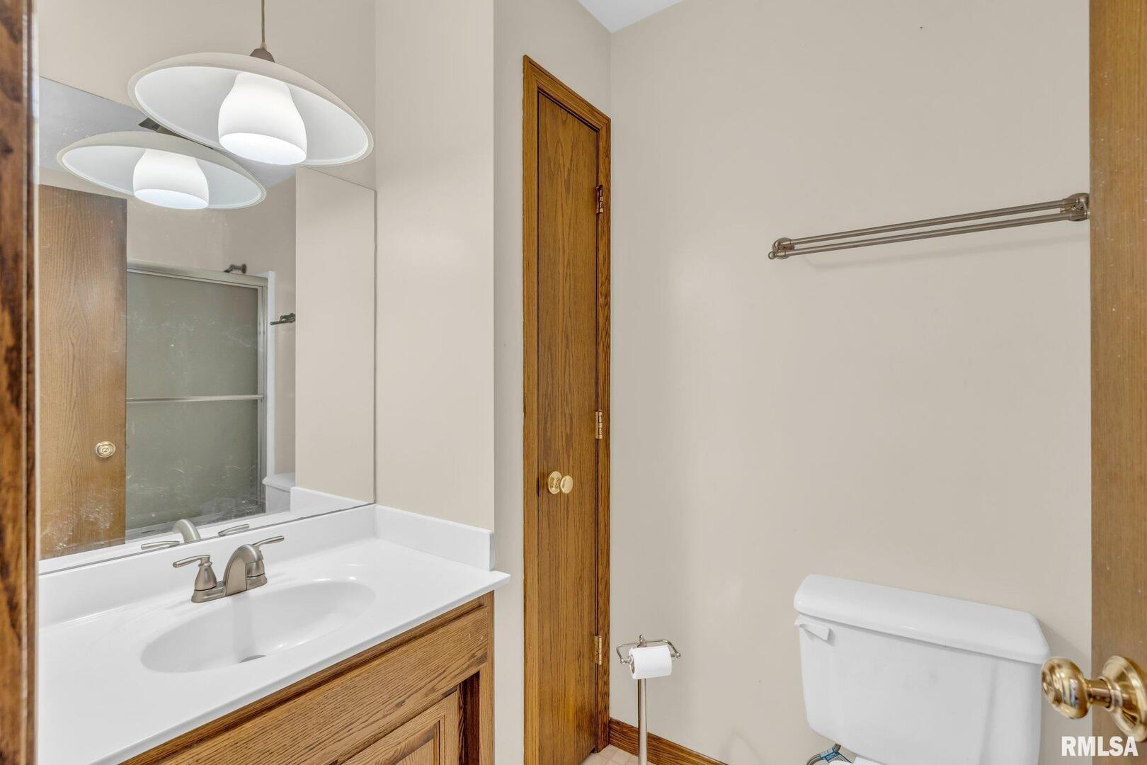 107 Hilltop Street Colona, IL 61241 - Photo 17 of 25 a bathroom with a sink and a mirror