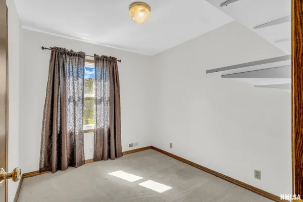 a view of a room with a empty space and a window