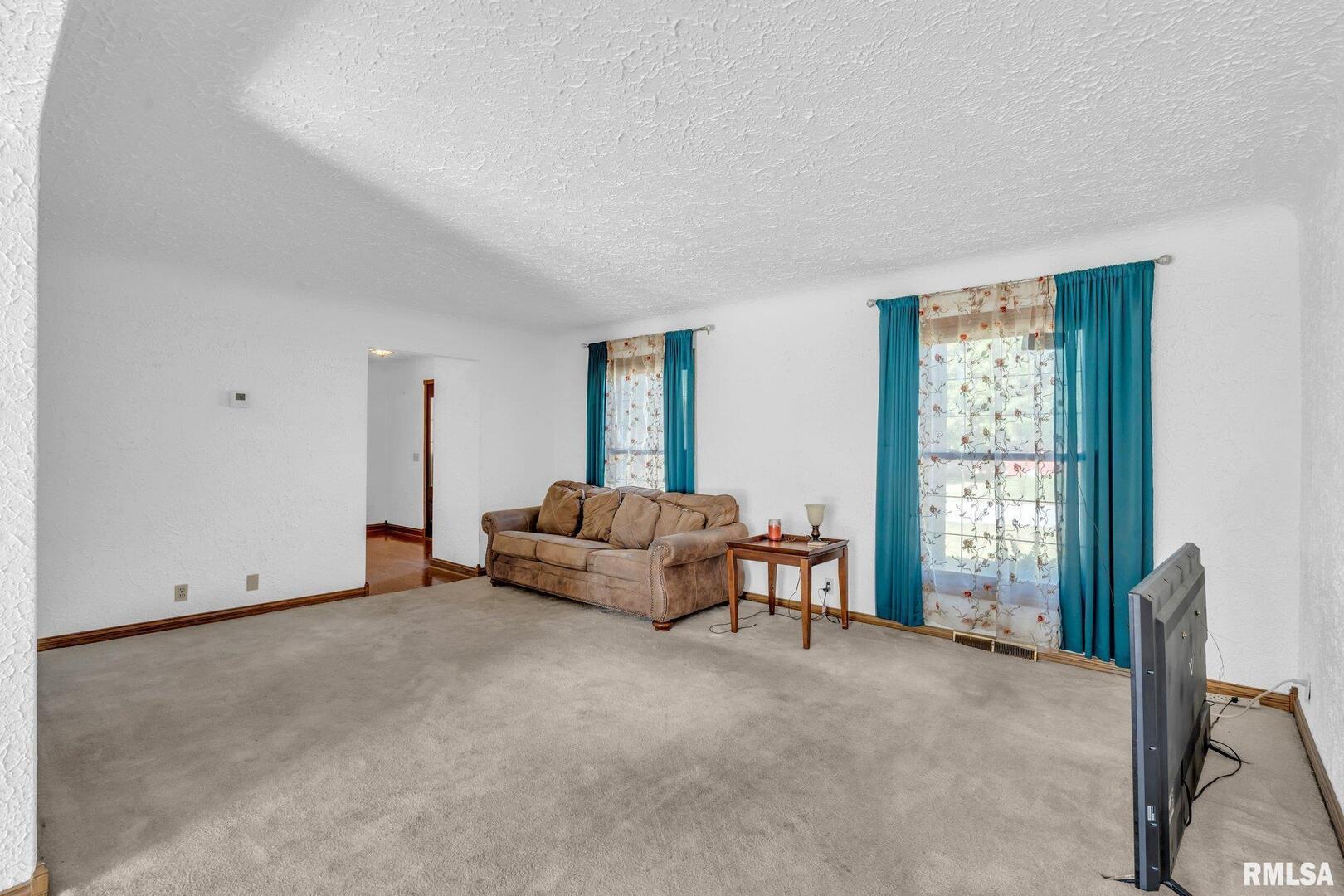 107 Hilltop Street Colona, IL 61241 - Photo 4 of 25 a living room with furniture and a window