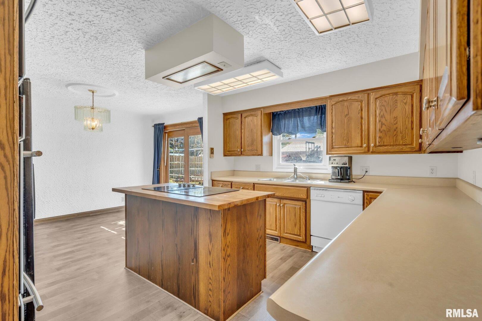 107 Hilltop Street Colona, IL 61241 - Photo 7 of 25 a kitchen with stainless steel appliances granite countertop wooden cabinets a sink and dishwasher