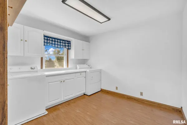 a kitchen with white cabinets and a sink