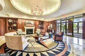a living room with fireplace furniture and a chandelier