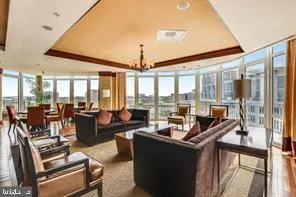 a living room with furniture city view and large windows