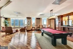 a spacious bedroom with a bed a table and large windows