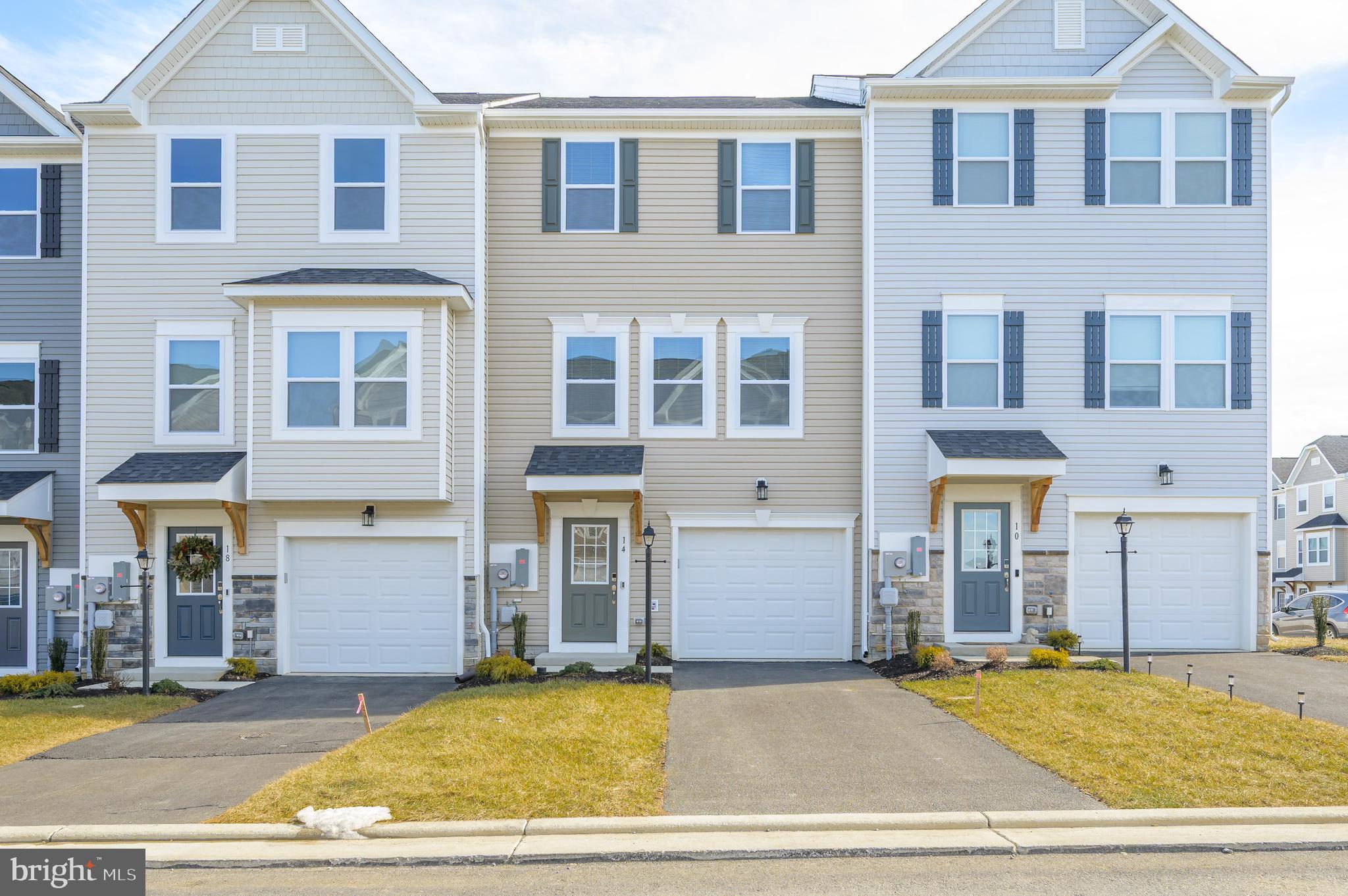 14 Trotting Road Inwood, WV 25428 - Photo 1 of 53 a view of a brick house with many windows and plants