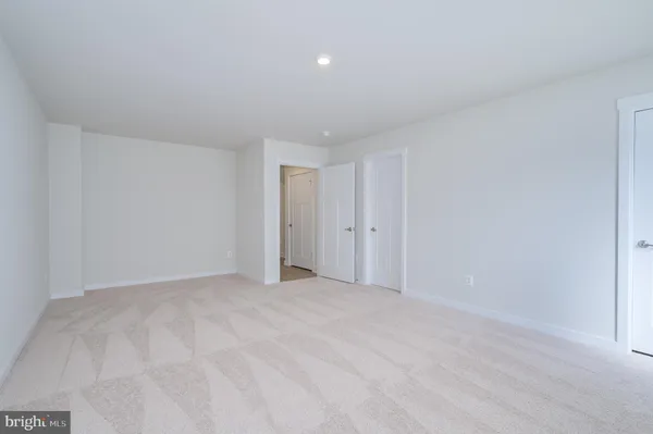 a bathroom with a toilet a sink a mirror and shower