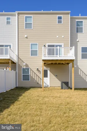 a view of a house with wooden fence