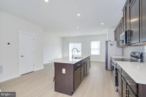 a kitchen with a sink stove and cabinets